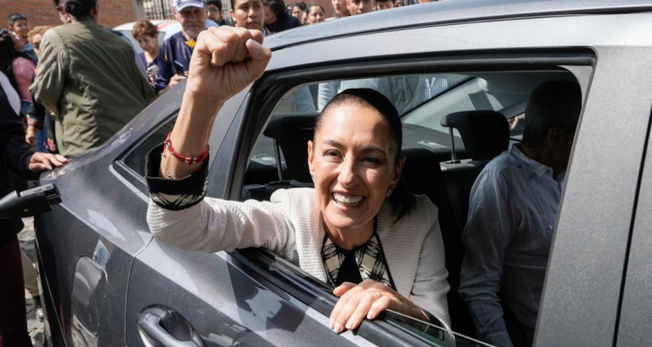 Mexicos new president putting a fist up our of a car window.